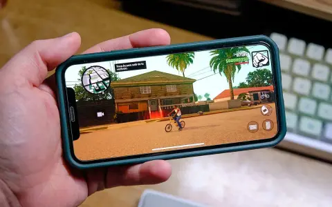Ręka trzyma smartfon z grą GTA: San Andreas. To świetny przykład darmowe gry na komórkę, które pozwalają na wirtualną rozrywkę.