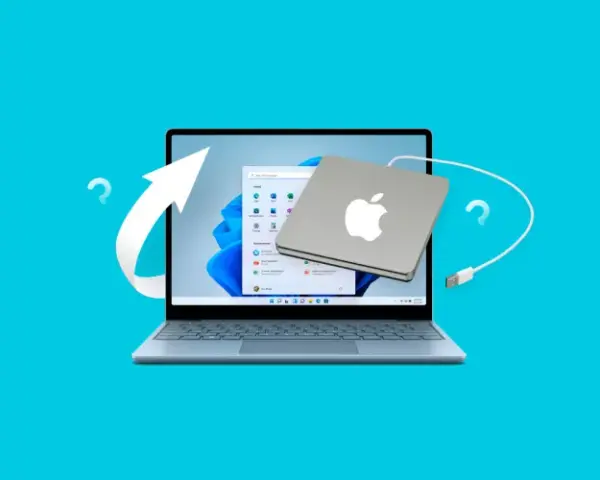 Jak zmienić hasło w komputerze? Laptop z systemem Windows i podłączony dysk Apple. Strzałka i znaki zapytania sugerują proces zmiany.